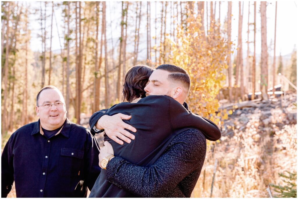 Families hugging after proposal